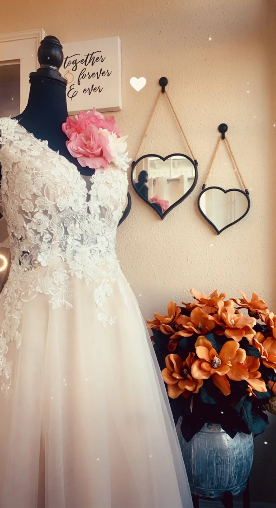 Lace bridal gown, floral accents, and heart mirrors inside Char Bridals